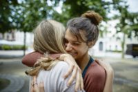 Two people hugging.