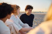 Three teens on the beach.