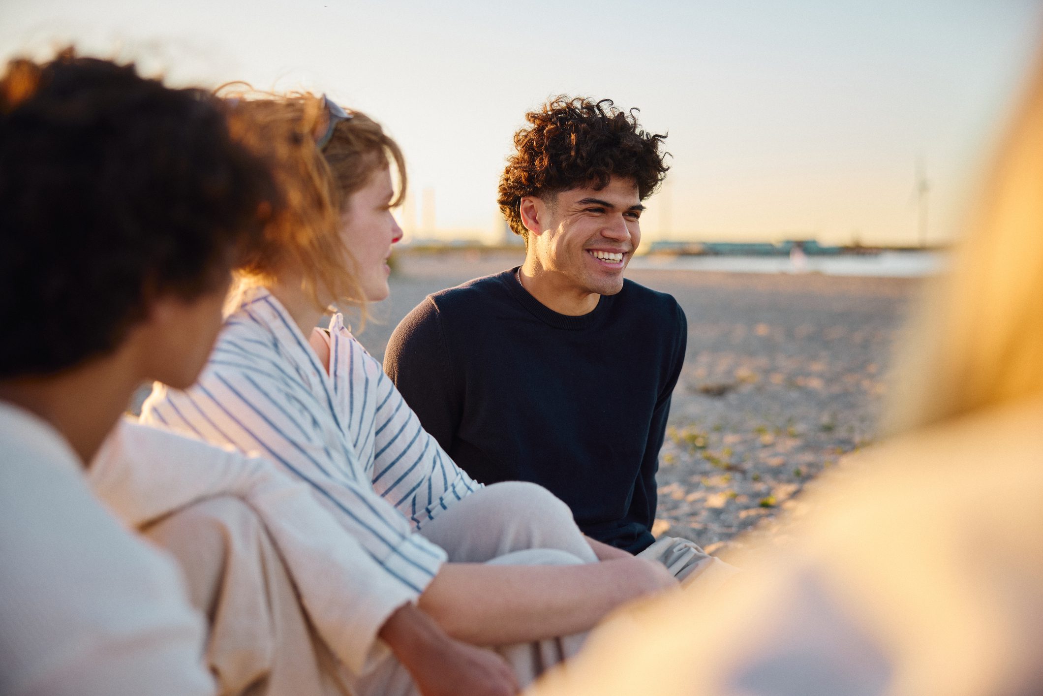 Three teens on the beach.